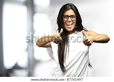 portrait of a pretty woman doing approve symbol indoor