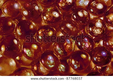 full frame abstract background picture with iridescent red glass beads