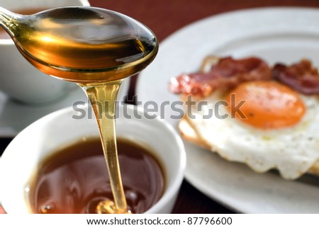 Picture of ham and eggs, tea and honey.