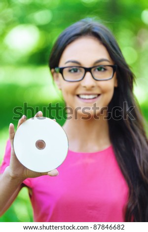 young girl smiling pink dress holding disc hand