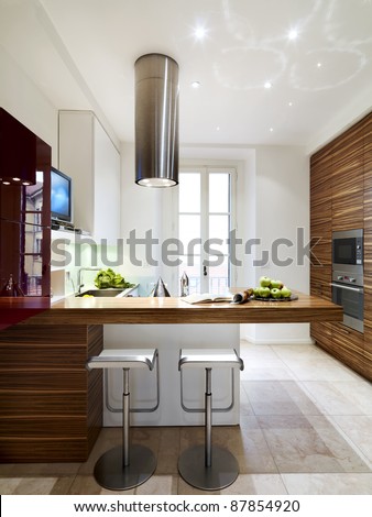 interior view of a modern and luxury wood kitchen with two stool Royalty-Free Stock Photo #87854920