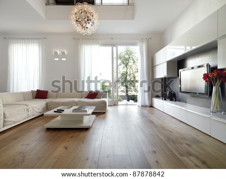 internal view of a modern living room with  wood flooring overlooking on the garden Royalty-Free Stock Photo #87878842
