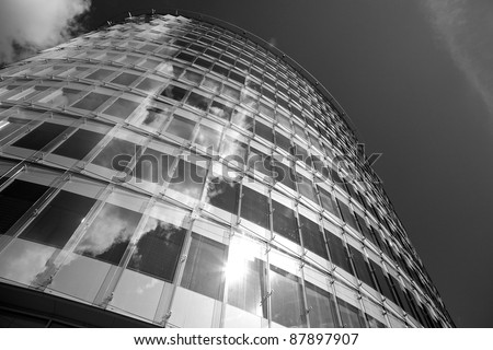 underside view to steel glass high rise building. Black-white photo.
