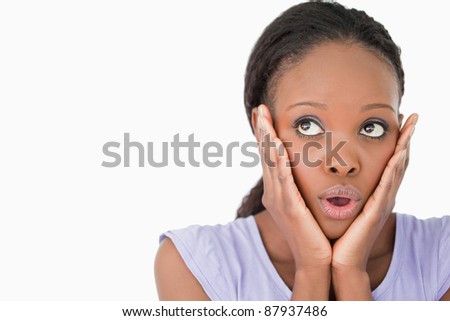 Close up of young woman being afraid against a white background