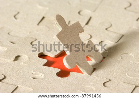 Paper puzzles on a red background. One puzzle is open. Royalty-Free Stock Photo #87991456