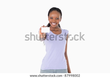 Smiling young woman presenting business card on white background