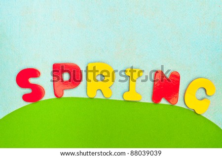 vibrant textured background of spring colours and spring in letters