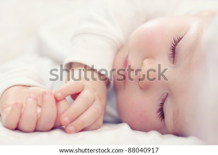 close-up portrait of a beautiful sleeping baby on white Royalty-Free Stock Photo #88040917