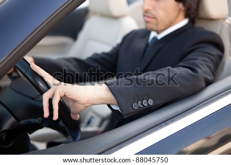 Young man in luxury sports car Royalty-Free Stock Photo #88045750