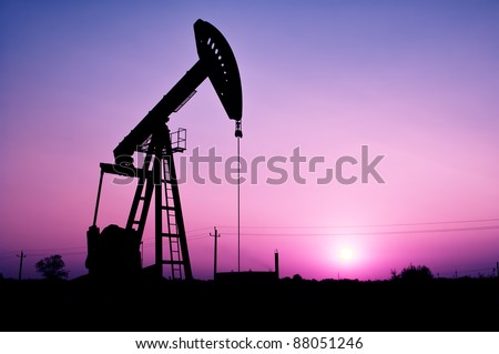 Pump jack silhouette at sunset