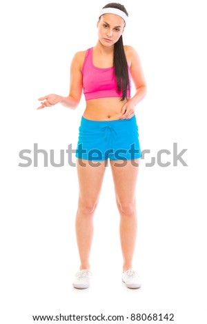 Unhappy girl in sportswear checking body fat isolated on white