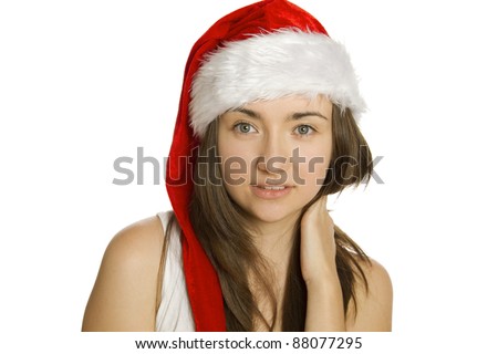 Close-up of a young attractive woman in a red hat santa. Isolated on white background