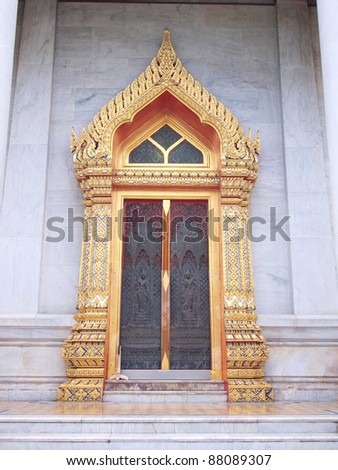 Vintage traditional Thai style door in marble temple , Thailand