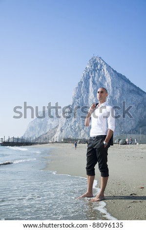 A business man taking a break on the beach