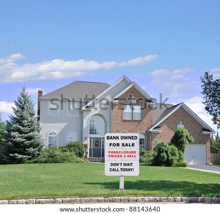 For Sale Sign on Front Yard Lawn of Landscaped Suburban Brick McMansion Home in Residential Neighborhood