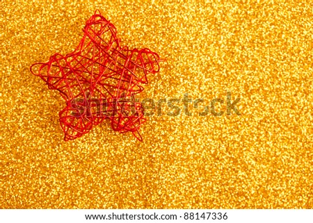christmas golden star of wire over golden glitter background
