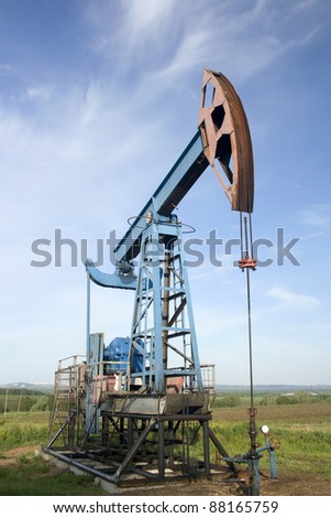 Oil and gas industry. Work of oil pump jack on a field. Environment damage