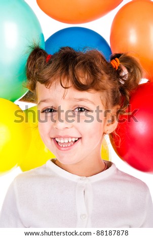 laughing girl on the background of color balloons