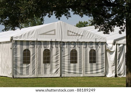 A white party or event tent on a meadow in a public park Royalty-Free Stock Photo #88189249