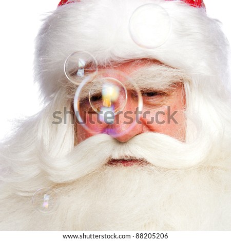 Santa Claus portrait smiling isolated over a white background and soap bubbles on foreground