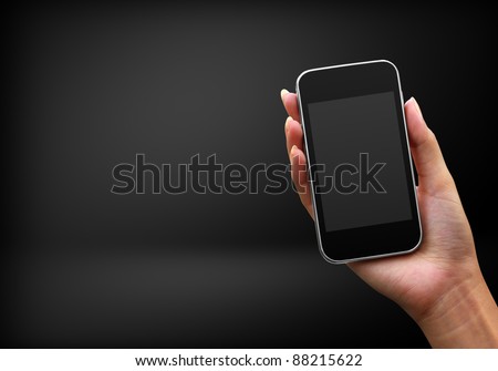 Mobile phone in hand on black background