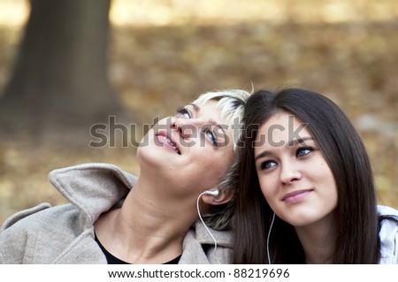 Two teenage girls listening to music