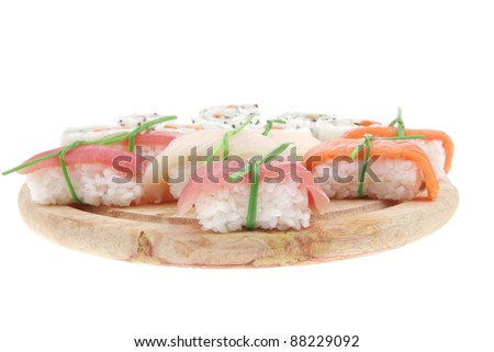 Maki Sushi and Nigiri - California Maki Roll made of fresh raw Salmon, Cream Cheese and Avocado inside with Nigiri Sushi topped with Salmon Tuna and Eel. Isolated over white background