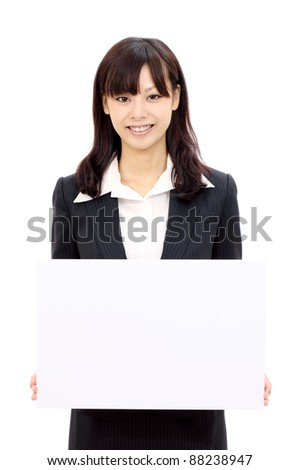 Happy japanese business woman holding blank card and smiling, white background