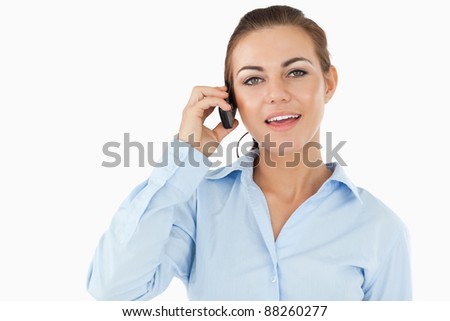 Businesswoman talking on her cellphone against a white background