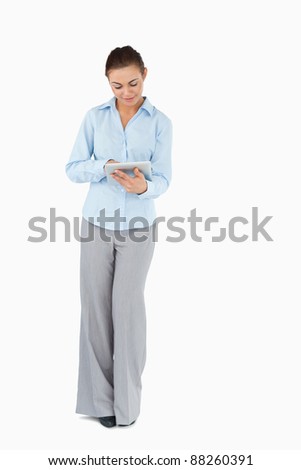 Young businesswoman with tablet against white background