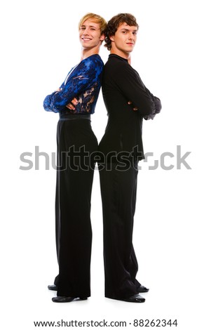 Two ballroom male dancers standing back to back