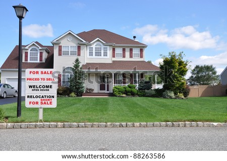 Realtor Relocation For Sale Sign on Beautiful Suburban Landscaped Home under Blue Sky with Clouds in Residential Neighborhood