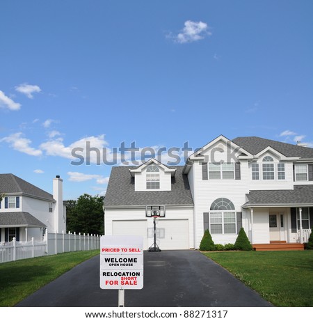 Realtor For Sale Sign at Driveway Edge of Suburban Home in Residential District