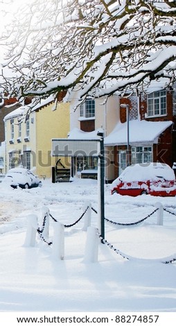 A blank signpost in snowy village perfect for adding own text