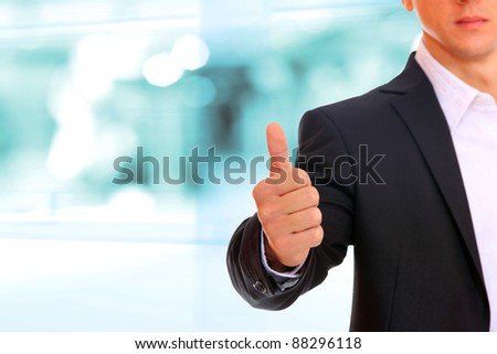 Business man shows thumb up