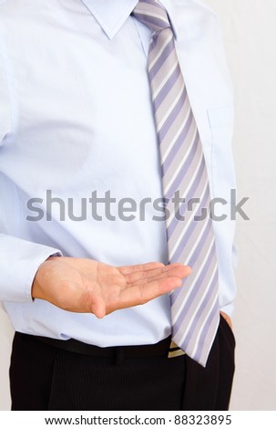 young business man holding hand presenting a product.
