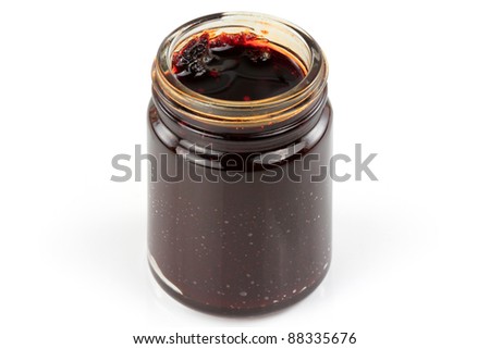 Closeup of a bottle of Thai spicy Chili Paste in oil, Chili Jam, Naam Prik Pao isolated on white background. It is the main ingredient to make tom yum goong hot soup