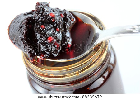 Closeup of a spoon of Thai spicy Chili Paste in oil, Chili Jam, Naam Prik Pao isolated on white background. It is the main ingredient to make tom yum goong hot soup
