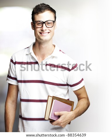 portrait of a happy student holding books indoor