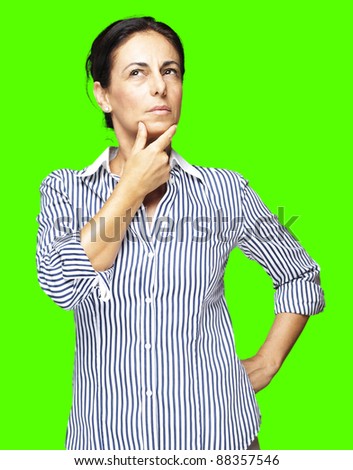 portrait of a middle aged woman thinking against a removable chroma key background