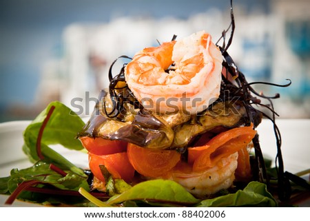 Delicious prawn starter with salad, aubergine and tomato. Royalty-Free Stock Photo #88402006