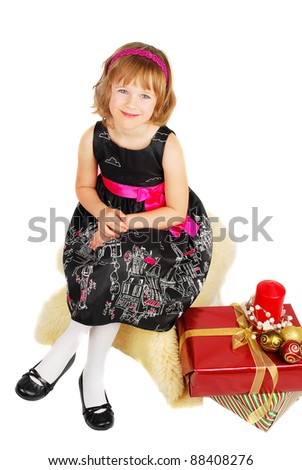 Picture of happy little girl sitting with gift christmas box happy and smile. Isolated on the white background.