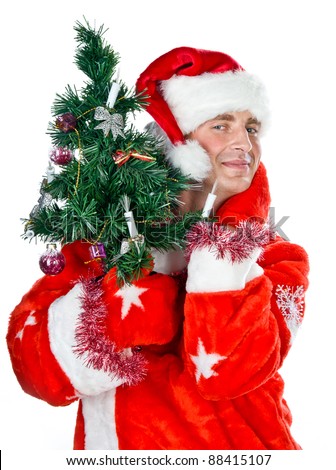 young funny guy in a costume of Santa Claus with Christmas tree in his hand, isolated over white