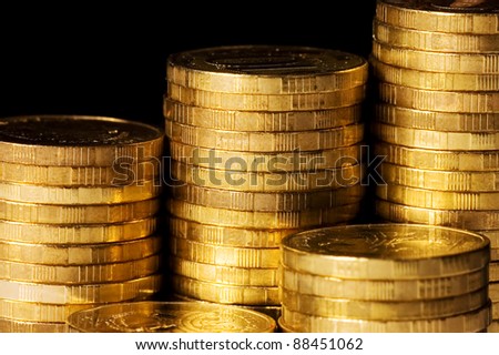 The golden coins isolated on black background