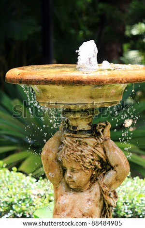 Water pumped into the air from Angel Sculpture Fountain in the garden. Cute ornamental structure in the garden