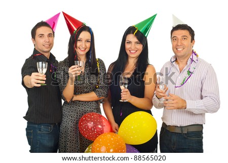 Group of four friends celebrating New Year's Eve together and holding glasses with champagne isolated on white background