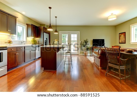 Modern new brown kitchen with cherry floor.