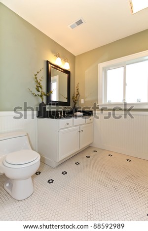Green new classic green bathroom with white ceramic tiles.