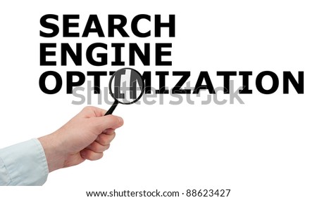 SEO - Man's Hand With Magnifying Glass on Search Engine Optimization Sign - Isolated on White