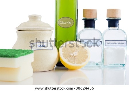 A range of natural, non-toxic cleaning products in containers on a shiny reflective surface with a white background. Royalty-Free Stock Photo #88624456